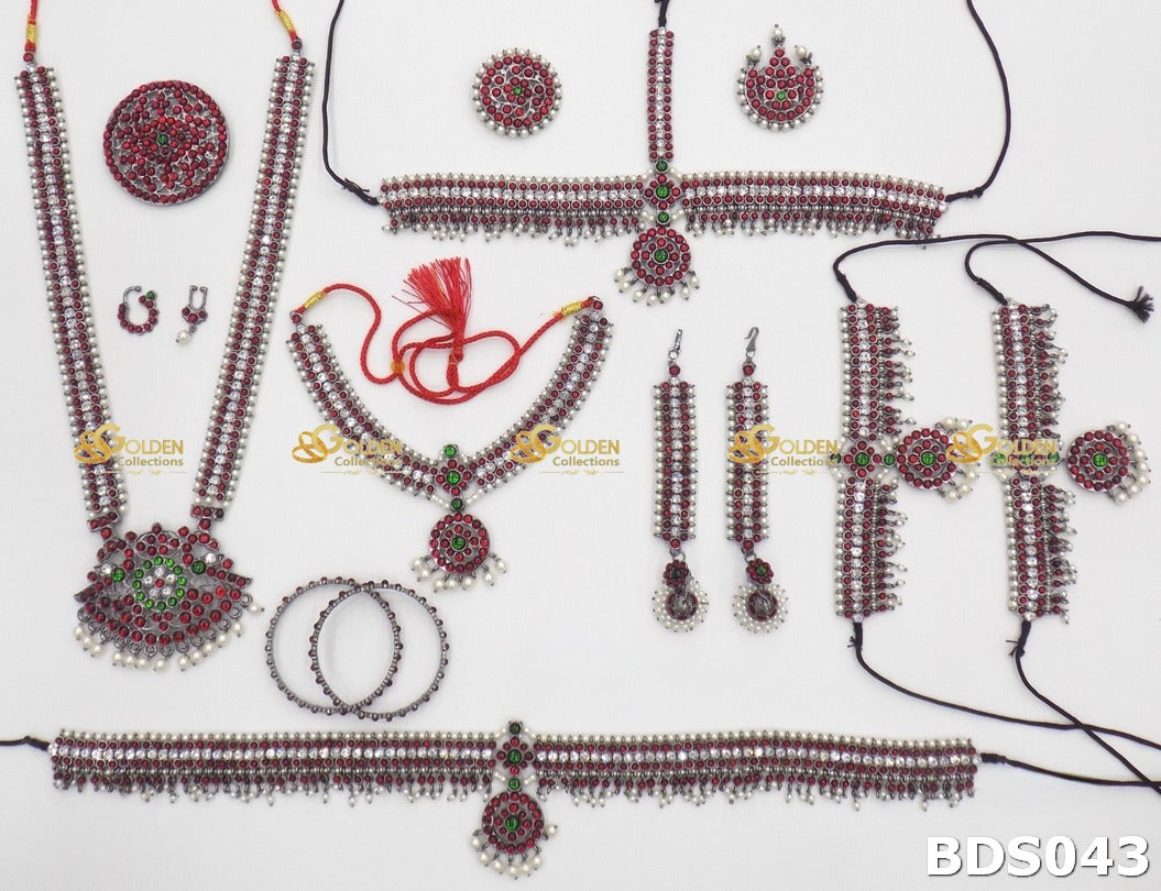 Complete antique temple jewellery set with Kemp stones, pearls, haram, choker, vaddanam, rakodi, earrings, bangles, armlets for Bharatanatyam dancers
