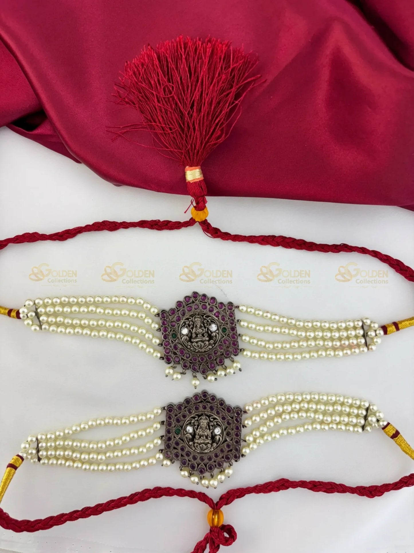 Golden Collections Black Kemp Multi-Strand Pearl Bajuband - Overhead view highlighting the intricate setting of black kemp stones and the lustrous finish of the pearls and traditional red cord.