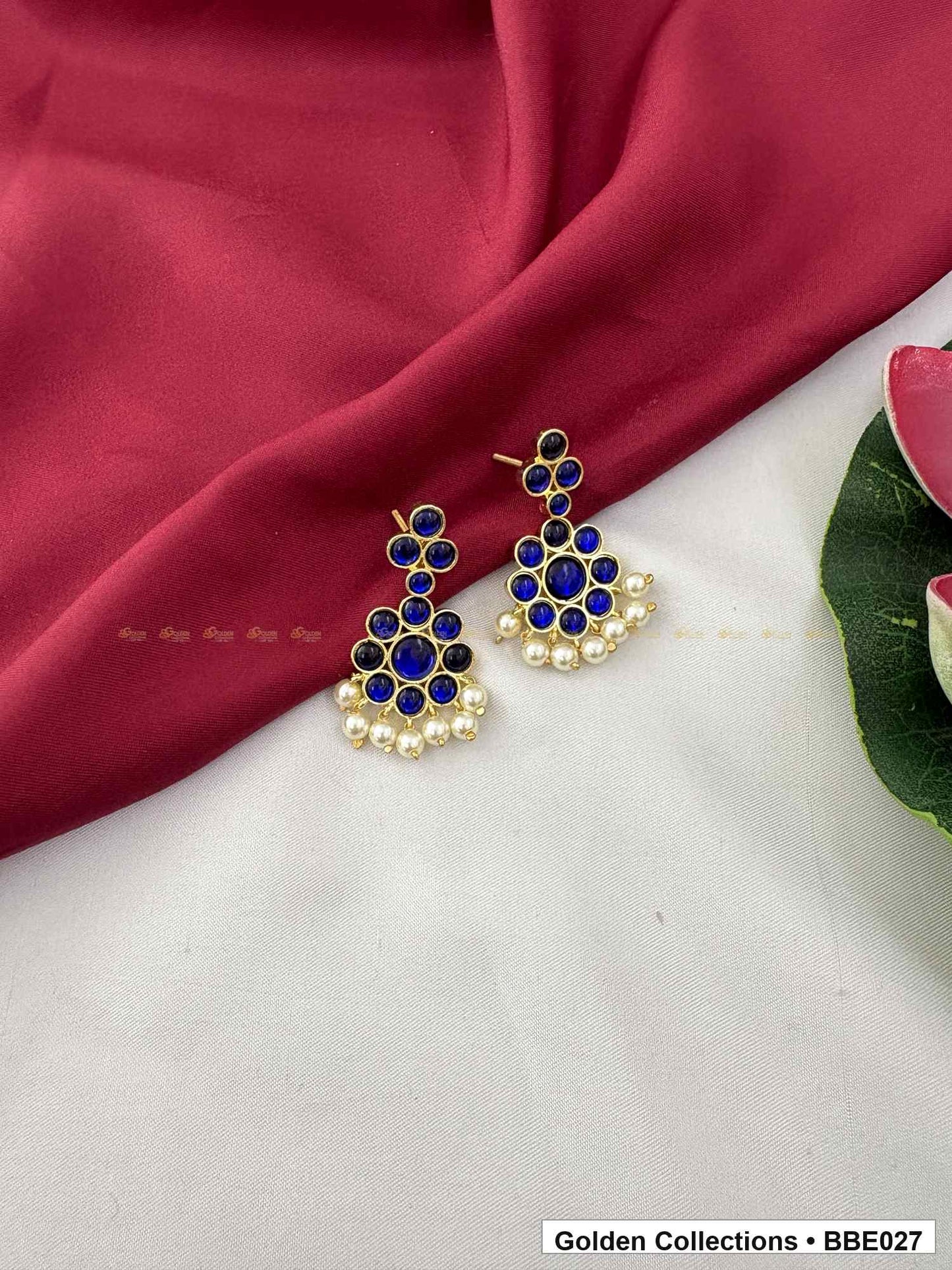 Angled product view of Blue Stone Real Kemp Jhumki Earrings from Golden Collections