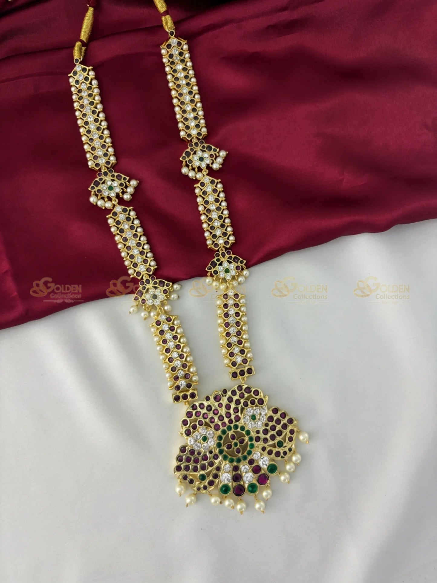 Golden Collections Kemp Long Necklace - Detailed view highlighting the intricate kemp stone arrangement and pearl drops on the peacock motif.