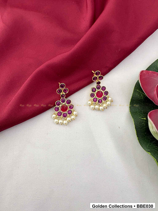 Angled product view of Pink Stone Pearl Real Kemp Jhumki Earrings from Golden Collections