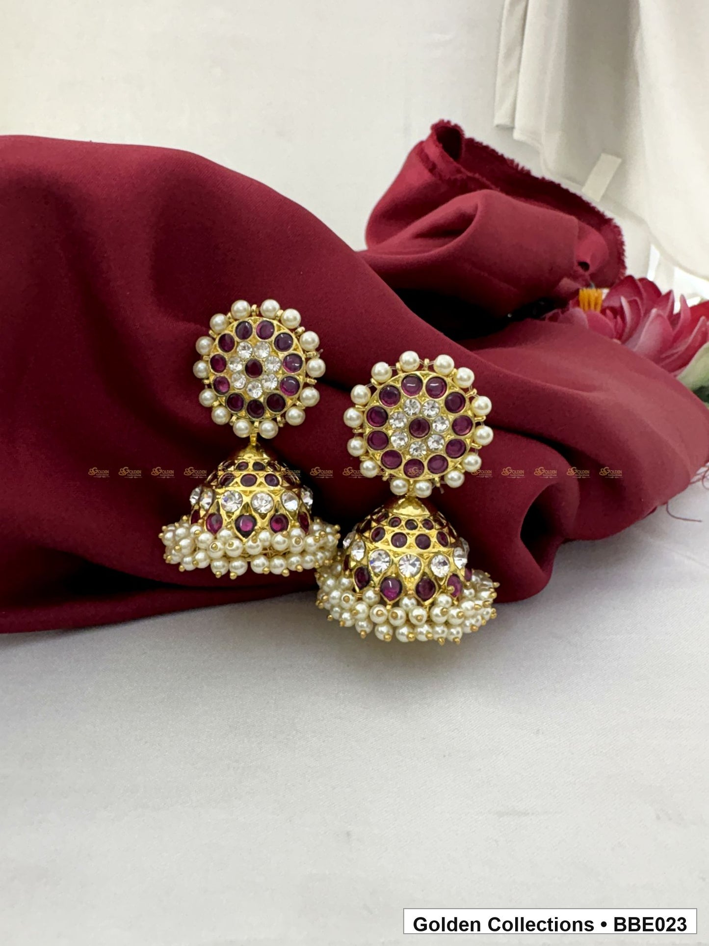 Angled product view of Red Stone Real Kemp Dome Jhumki Earrings from Golden Collections