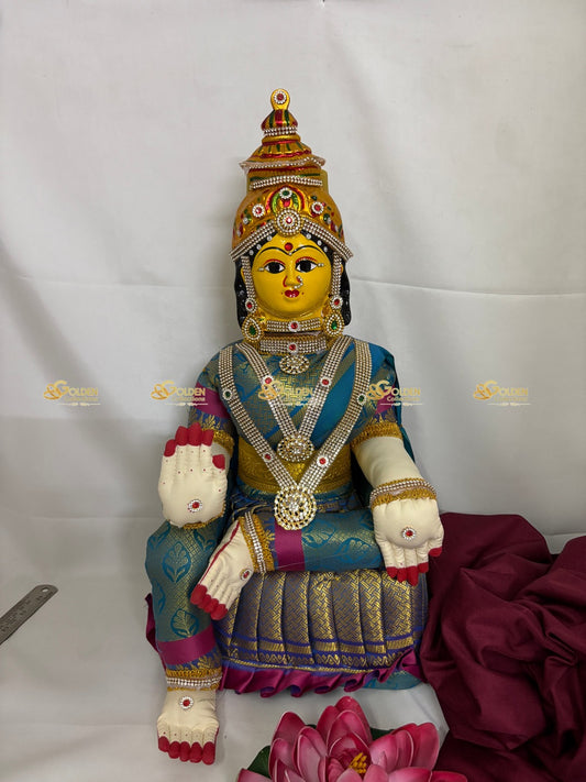 Colorful statue of a deity with intricate details on a white background