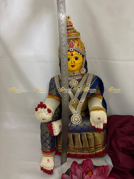 Decorative figurine with intricate details and a ruler for scale on a white background