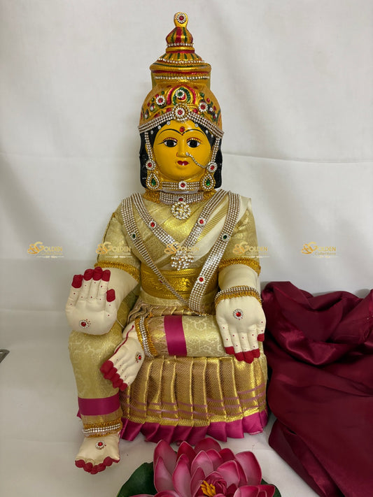 Decorative statue with gold and pink attire on a white background