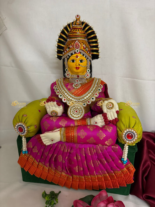Colorful statue of a deity in traditional attire on a white background