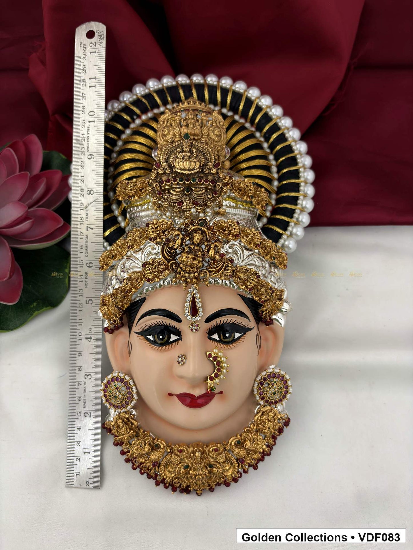 Varalakshmi Tanjore Face with Layered Motif Crown and Red-Green Necklace close-up detail view