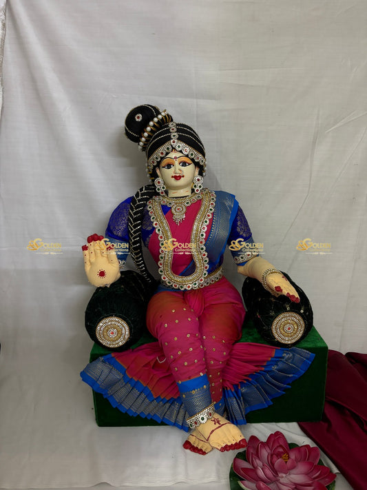 Colorful statue of a deity in traditional attire on a white background