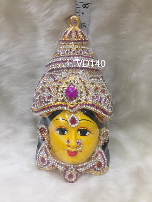  Graceful face of Varalakshmi adorned with a majestic golden crown, embodying her divine status as the bestower of wealth and prosperity.