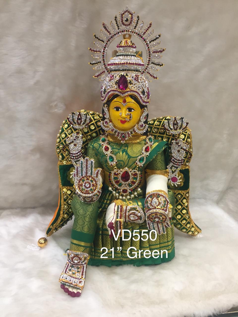 Goddess Varalakshmi idol with a golden crown surrounded by lotus flowers, representing wealth and prosperity for Varalakshmi Vratham festival.