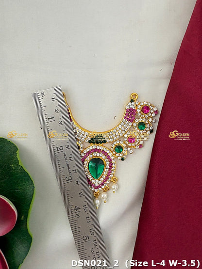 Decorative necklace with gemstones and pearls next to a ruler on a white background