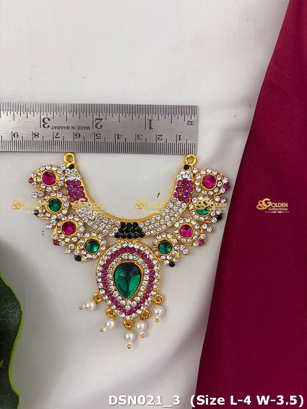Decorative necklace with gemstones and pearls on a white background with a ruler for scale.