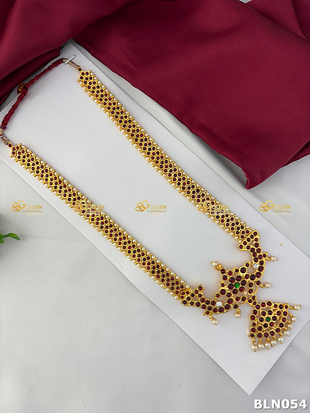 bharatanatyam pearl long haram with peacock kemp pendant and ruby stones
Goldencollections