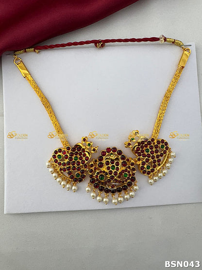 Bharatanatyam short necklace with Kemp snake design ruby green stones and pearl drops Goldencollections
