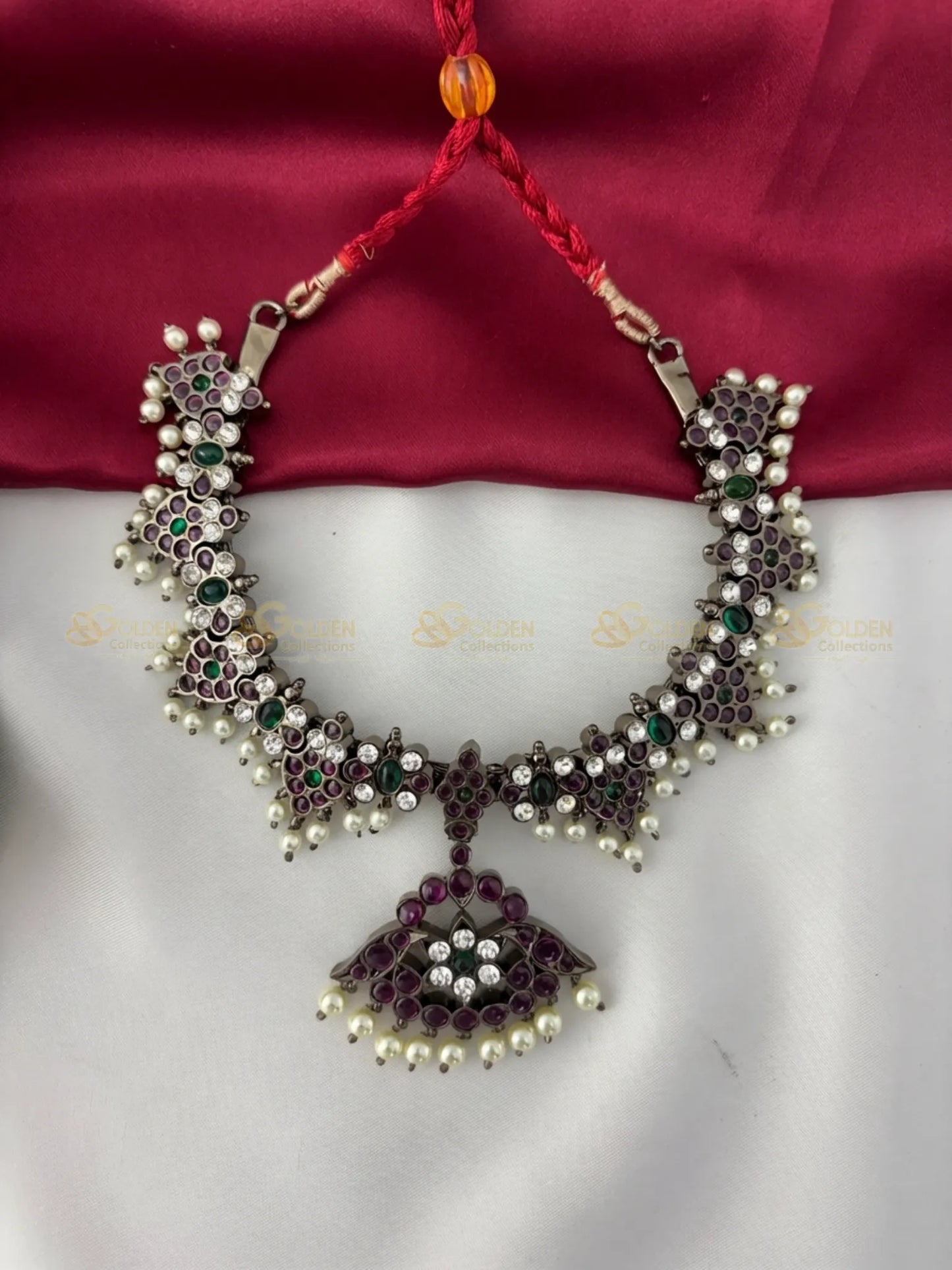 Golden Collections Black Kemp Floral Short Necklace - Front view showcasing the intricate floral motifs and central pendant with ruby, emerald, and white genuine stones, accented by genuine pearls.