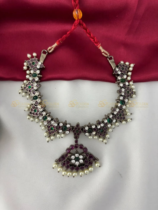 Golden Collections Black Kemp Floral Short Necklace - Front view showcasing the intricate floral motifs and central pendant with ruby, emerald, and white genuine stones, accented by genuine pearls.