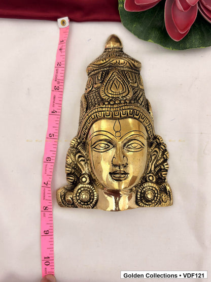 Measurement view of Brass Varalakshmi Face with Tall Embossed Crown and Circular Earrings with ruler beside the face