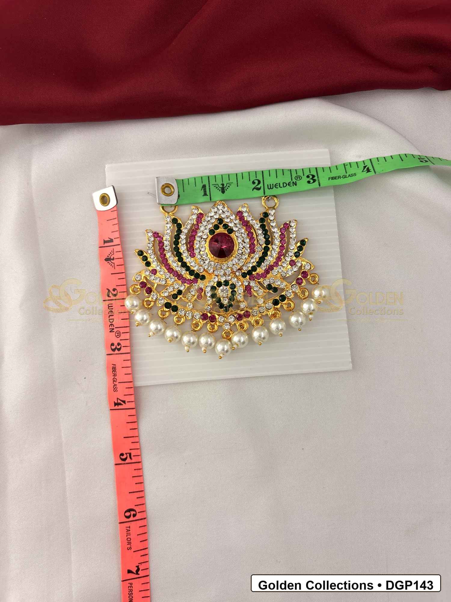 Measurement photo showing 3 x 3.5 Inches crown motif deity pendant for idol alankaram with ruler for idol alankaram