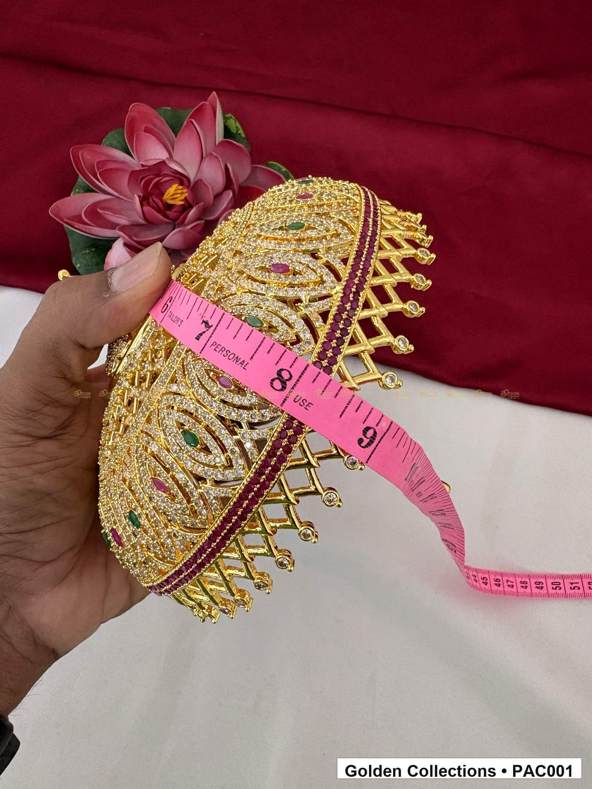 CZ deity umbrella held beside a pink measuring tape for measurement reference, with the domed profile and structured lower edge visible.