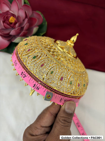 Close measurement view of the CZ deity umbrella beside a pink measuring tape, showing the decorated dome, finial, lower edge, and bead-like drops.