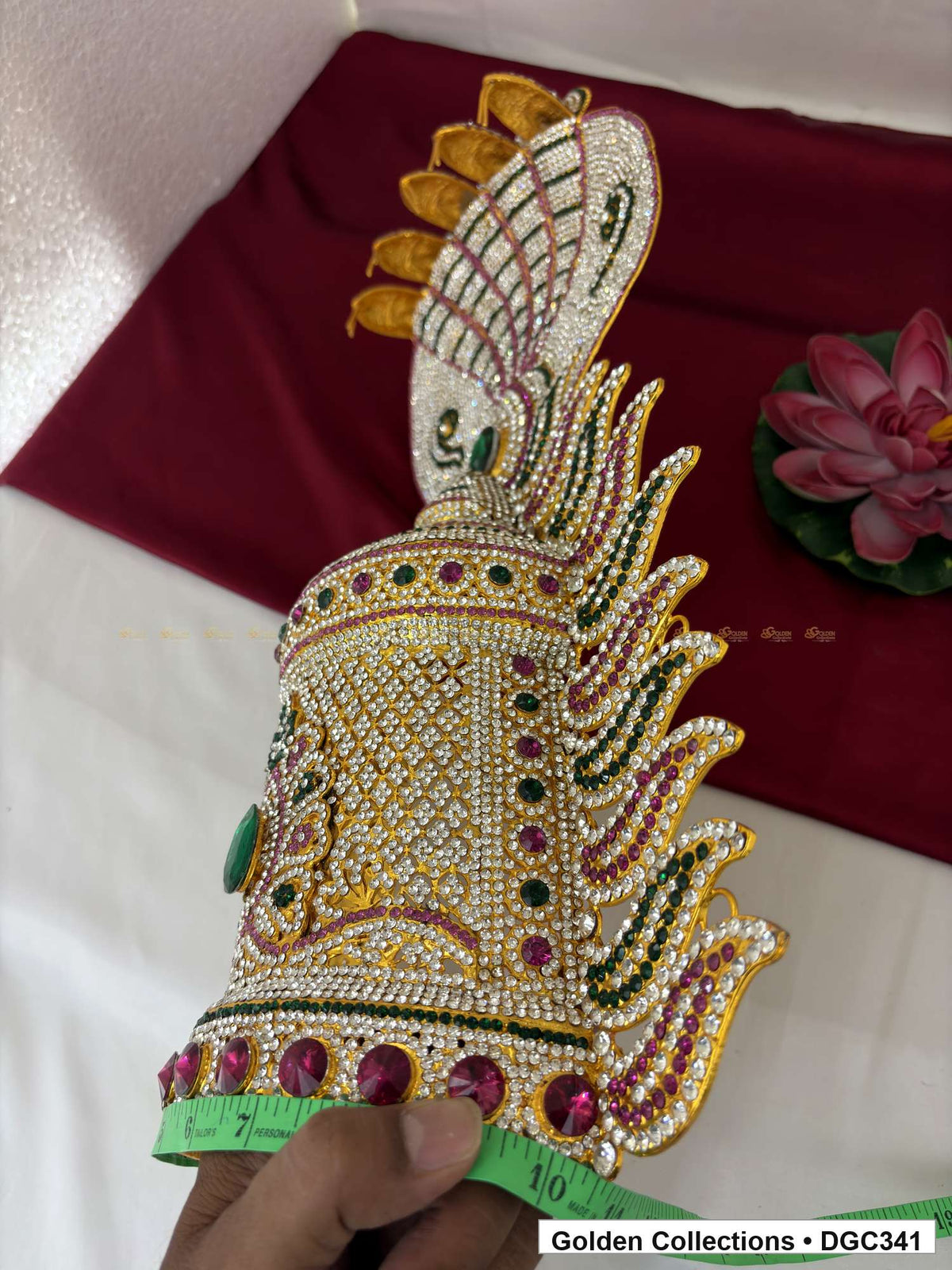 Angled side view of crown showing its curved body, projecting paisley-shaped details and crest-tip undersides, with a measuring tape held around the base.