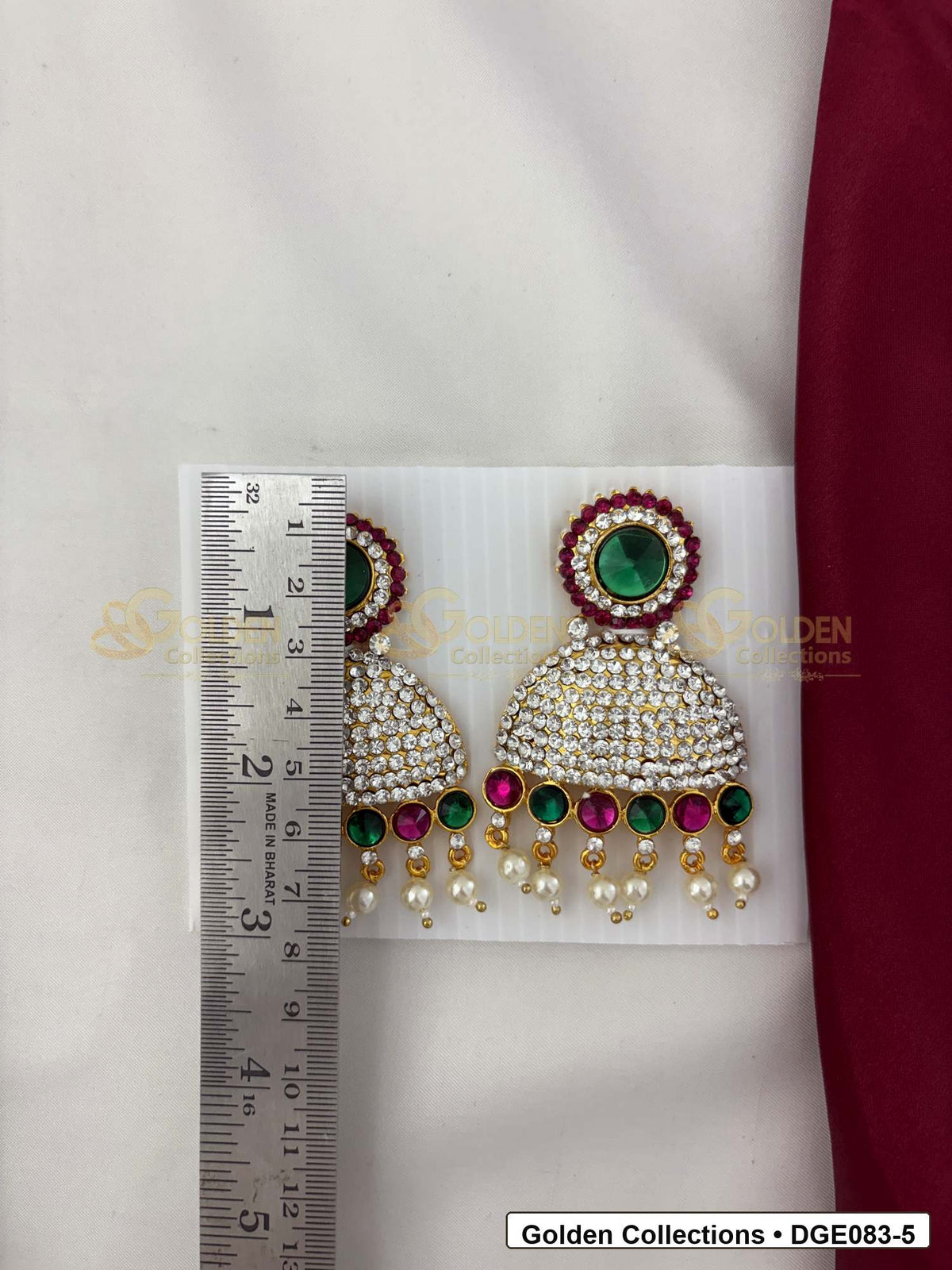 Measurement photo showing 8 Cms dome deity earrings with pink green stones for idol alankaram for deity idol alankaram