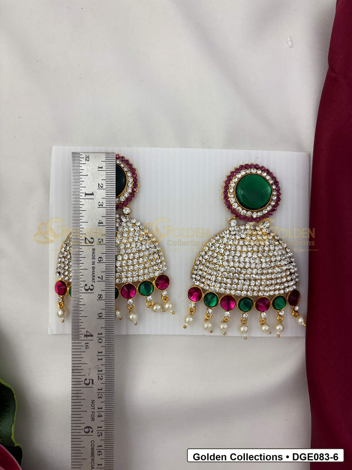 Measurement photo showing 9 Cms dome deity earrings with pink green stones for idol alankaram for deity idol alankaram