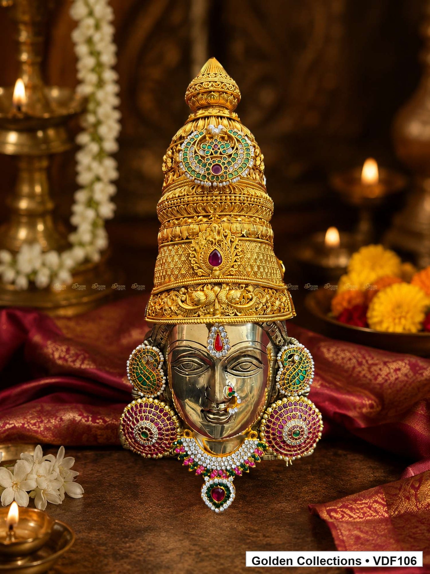 Fully Decorated Brass Varalakshmi Face with Nakshi Crown and Green Jadau Earrings shown in a Varalakshmi Vratham pooja setting