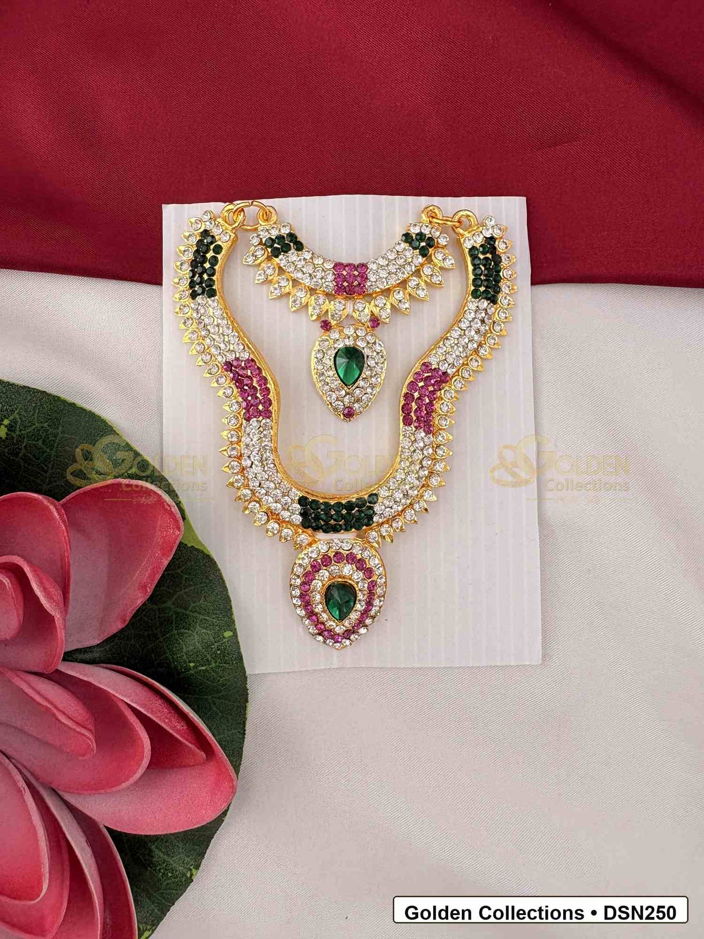 Front view of Goddess Idol Short Necklace with Green Pink Side Stones showing short necklace with green side stone sections, pink accent stones, pearl-like rows and a teardrop center pendant