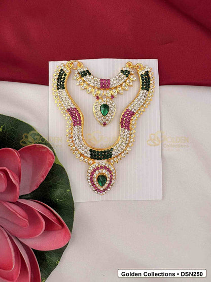 Front view of Goddess Idol Short Necklace with Green Pink Side Stones showing short necklace with green side stone sections, pink accent stones, pearl-like rows and a teardrop center pendant