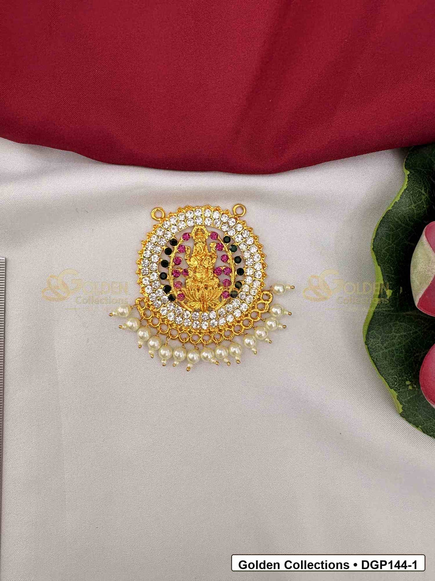 Goddess Motif Round Deity Pendant for Idol Alankaram front view showing round goddess motif deity pendant with gold-tone center, pink and green accent stones, clear stone border and pearl-style bead edge for idol alankaram