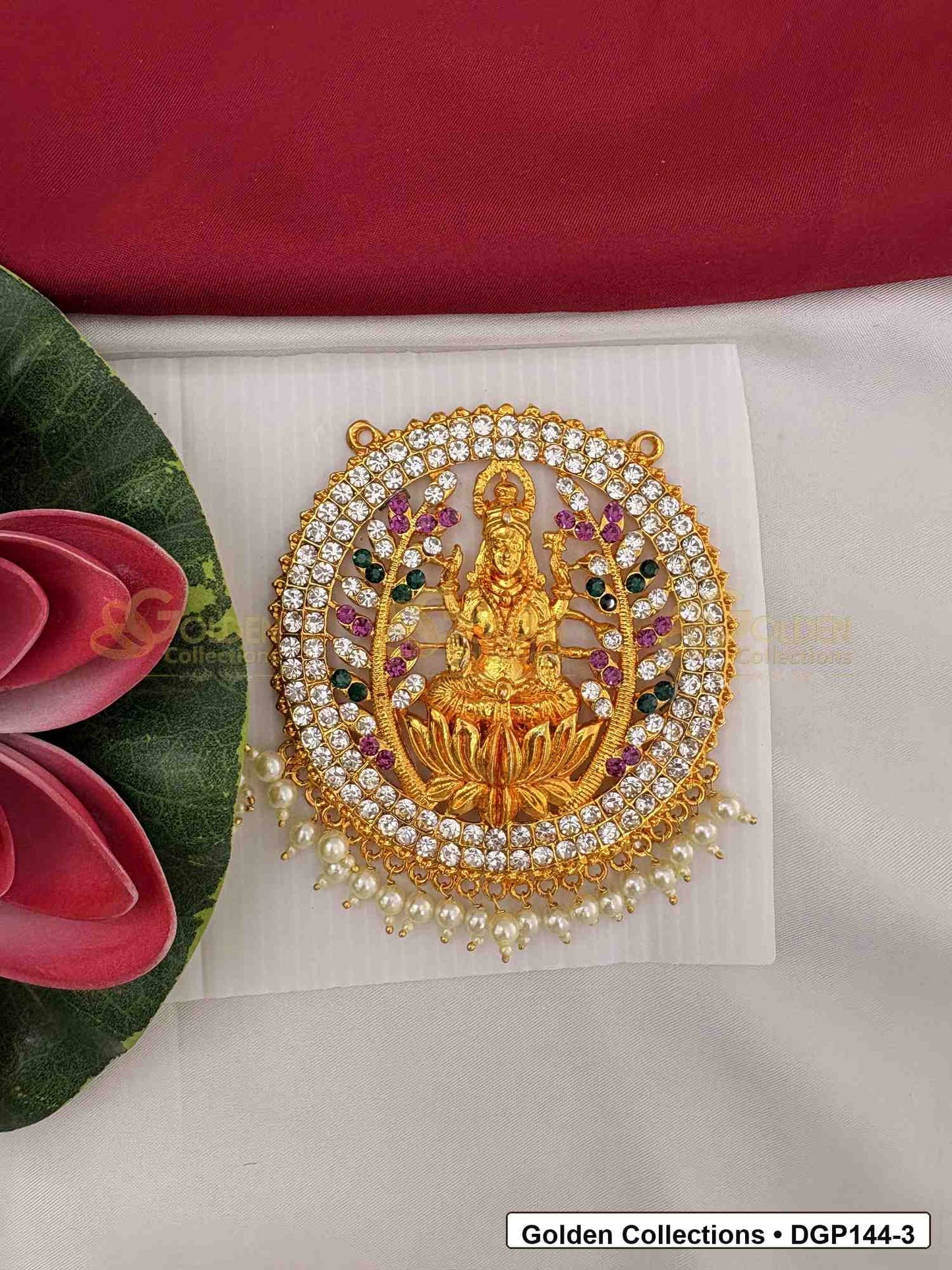 Goddess Motif Round Deity Pendant for Idol Alankaram front view showing round goddess motif deity pendant with gold-tone center, pink and green accent stones, clear stone border and pearl-style bead edge for idol alankaram