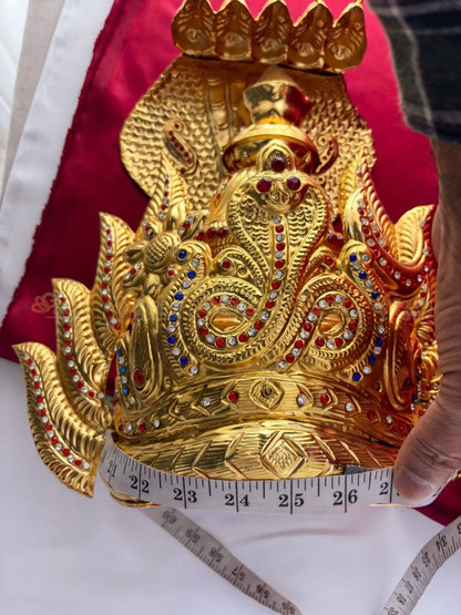 Golden Collections Gold Plated Nagaraja Naga Kireedam Crown - Close-up view showing the circumference being measured, highlighting the detailed gold plating and vibrant stones.