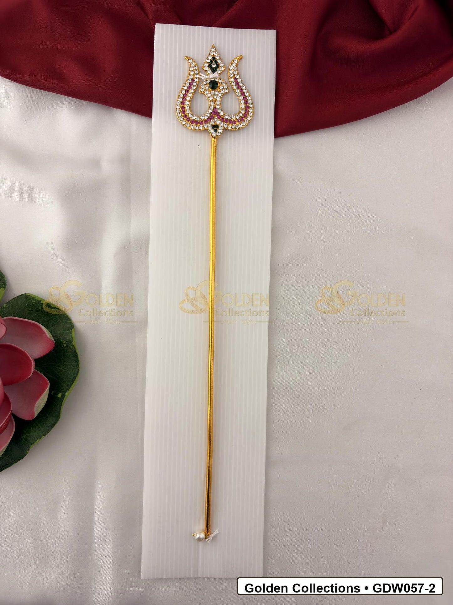Gold-Tone Trishul for Idol Alankaram front view showing slender gold-tone trishul accessory with clear stone border, small green accent and pearl-style tip detail for idol alankaram