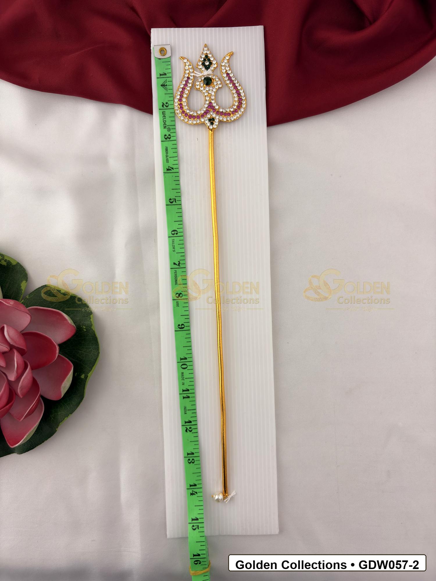 Measurement photo showing 14 Inches gold-tone trishul for idol alankaram with measuring tape for idol alankaram