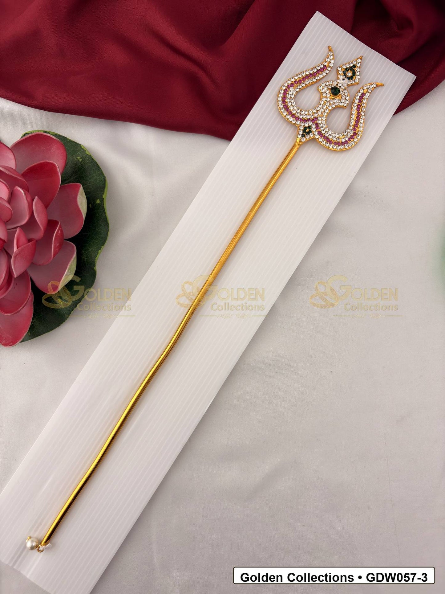 Gold-Tone Trishul for Idol Alankaram front view showing slender gold-tone trishul accessory with clear stone border, small green accent and pearl-style tip detail for idol alankaram