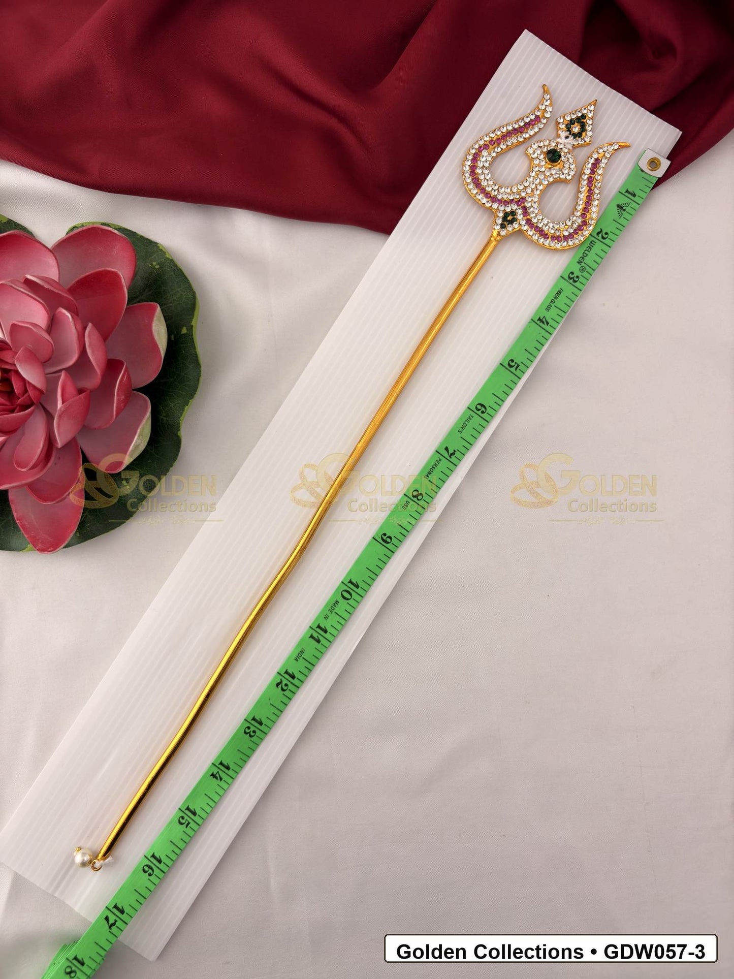Measurement photo showing 17 Inches gold-tone trishul for idol alankaram with measuring tape for idol alankaram