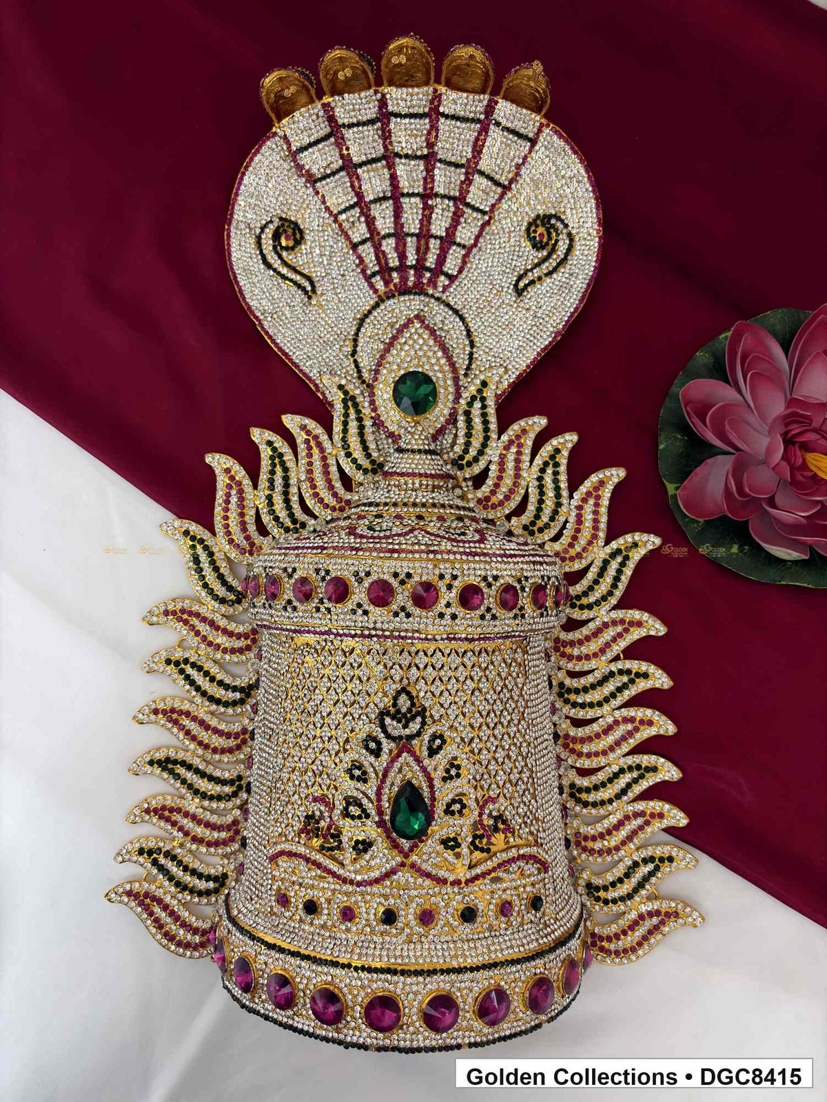 Front view of the half-round deity stone crown with a snake-motif top, white decorative details, and green and magenta accents.