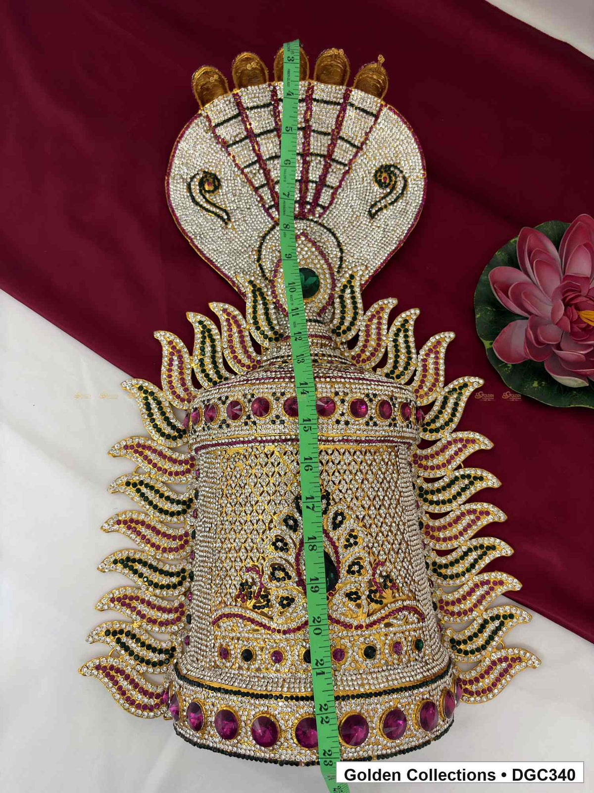Front view of the half-round deity stone crown with a vertical tape measure running from the top toward the base.