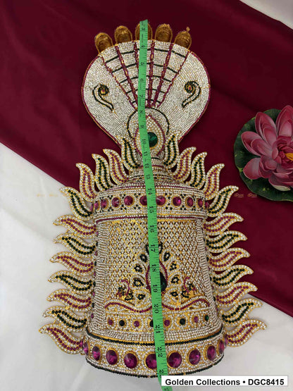 Front view of the half-round deity stone crown with a vertical tape measure running from the top toward the base.