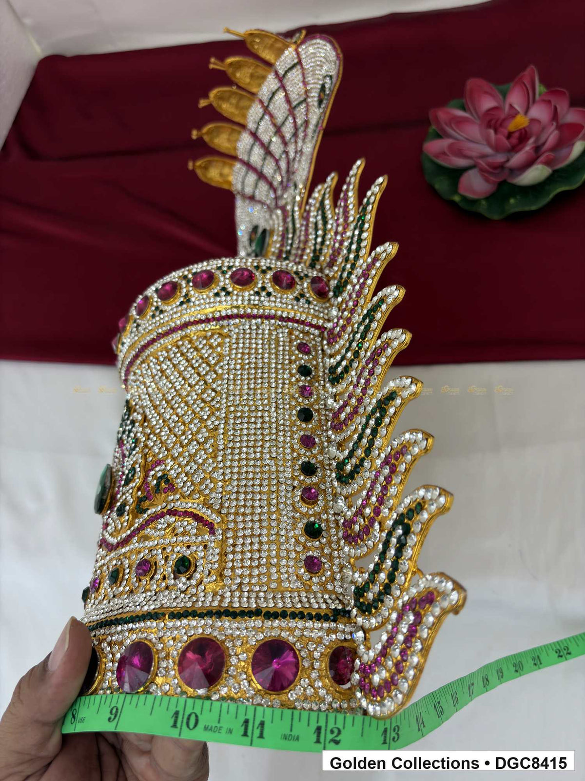 Side view of the half-round deity stone crown with a tape measure wrapped around its base.