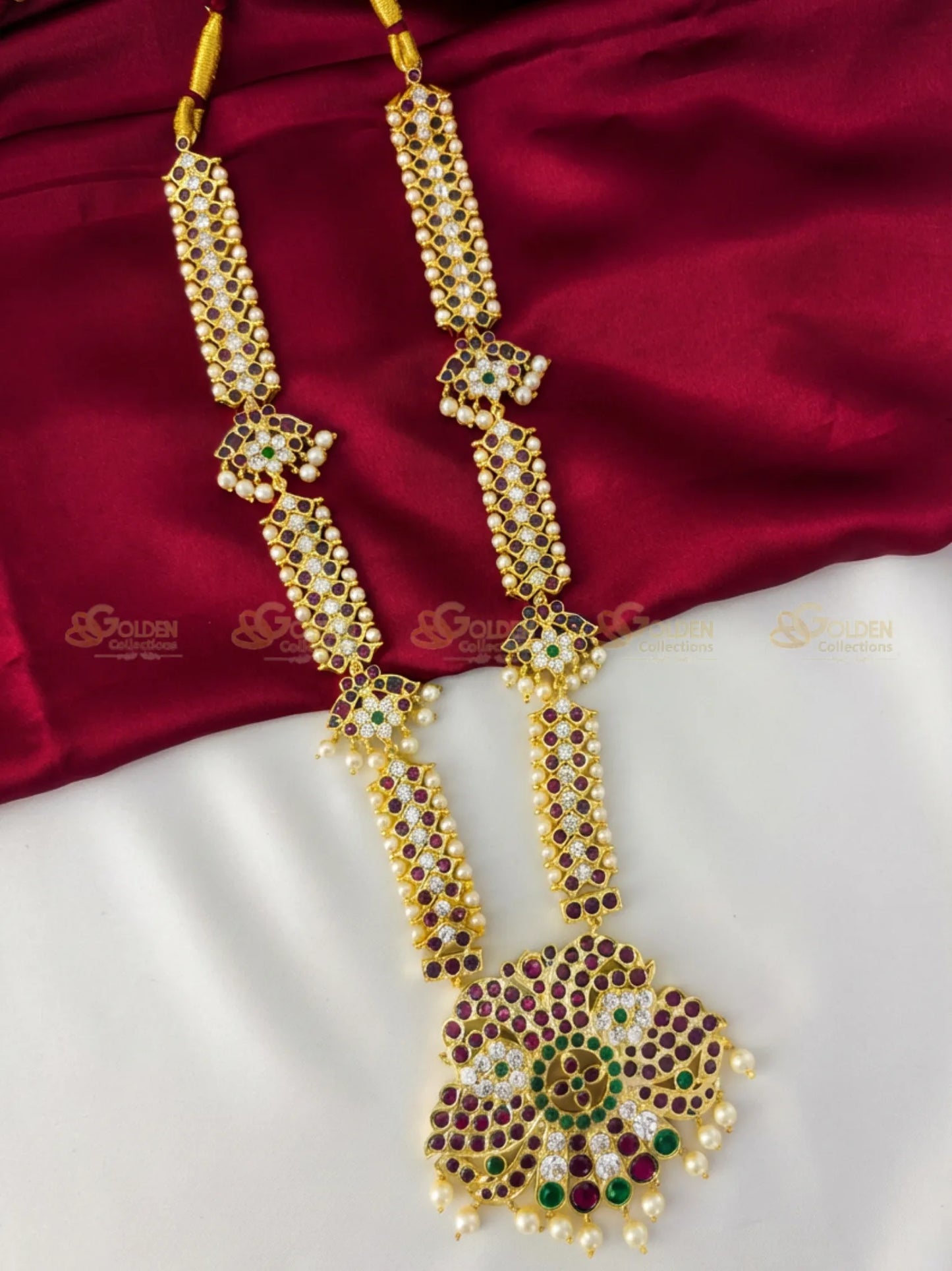 Golden Collections Kemp Long Necklace - Front view showcasing the ornate peacock pendant and rich ruby and green kemp stones.