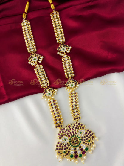 Golden Collections Kemp Long Necklace - Front view showcasing the ornate peacock pendant and rich ruby and green kemp stones.