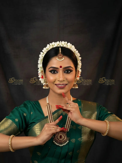 Golden Collections Kemp Mattal Gold - Model wearing temple jewelry with green silk saree.