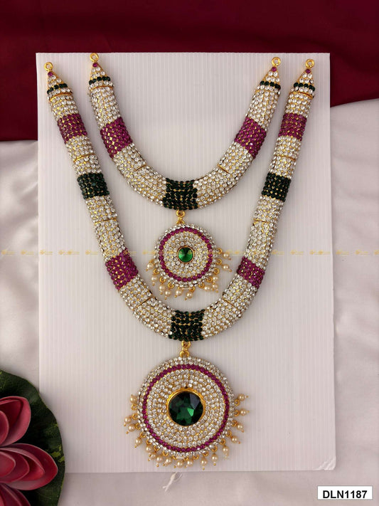 Front view of deity long haram set with multicolor stones and gold plating for idol alankaram