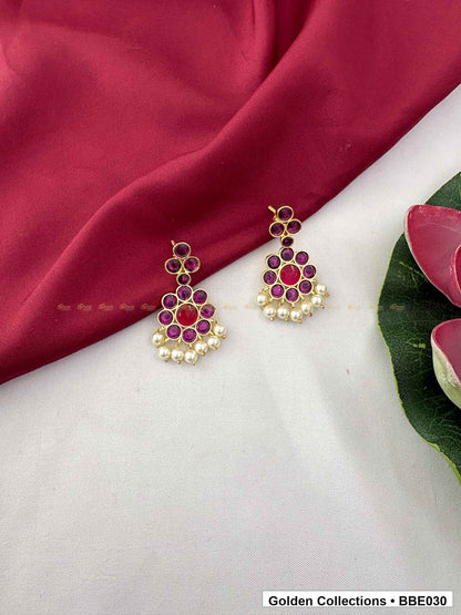 Angled product view of Pink Stone Pearl Real Kemp Jhumki Earrings from Golden Collections