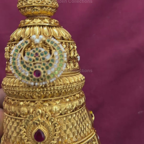 Fully decorated brass Varalakshmi face with green Jadau earrings shown in product video