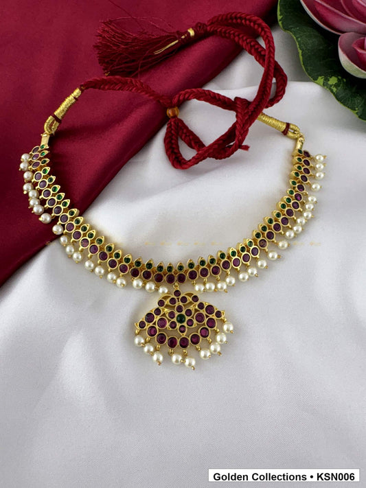 Front view of Red Stone Real Kemp Crescent Necklace with Pearl Border from Golden Collections