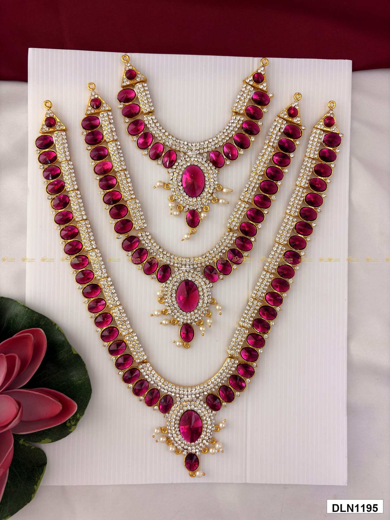 Front view of deity long haram set with multicolor stones and gold plating for idol alankaram