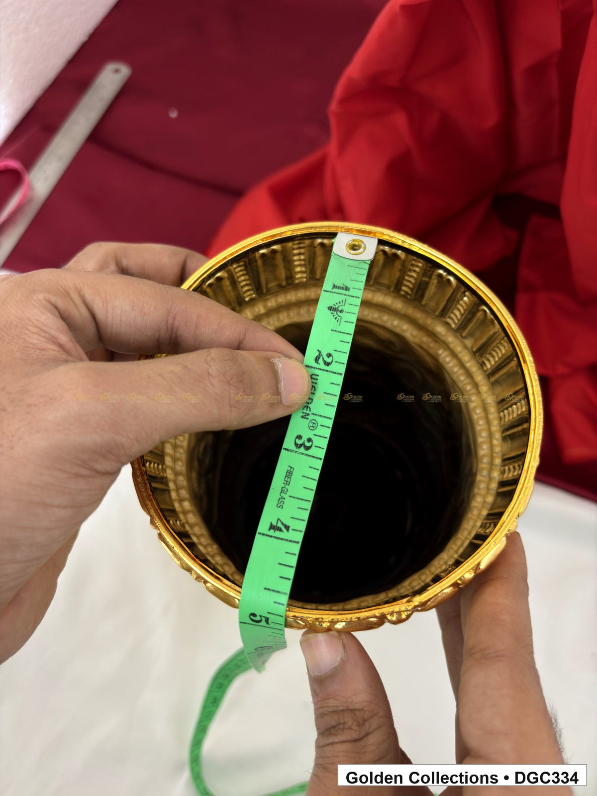 Opening measurement view of scroll medallion full-round brass deity crown with red green accents, measured size 11 X 15.5 X 4.5